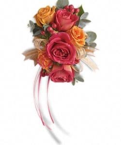 Warm orange and pink roses evoke the splendor of sunset wrist corsage.