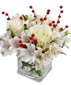 white roses and alstroemeria with red holly berries in cube