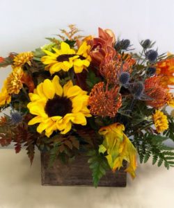 sunflowers and wildflowers in wood box