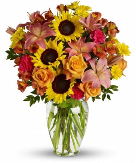 Rustic yet ravishing, this glorious array of sunflowers blended with delicate orange roses and pink lilies combines simplicity with sophistication