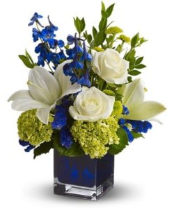 exquisitely lyrical bouquet in a chic contemporary glass cube vase is sure to impress anyone.