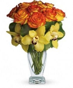 A stunning modern arrangement featuring one dozen orange bi-color roses and fresh yellow cymbidium orchids