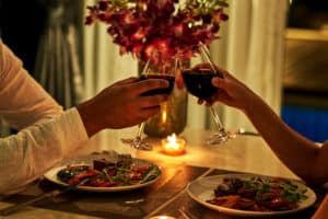 Romantic dinner with wine and flowers