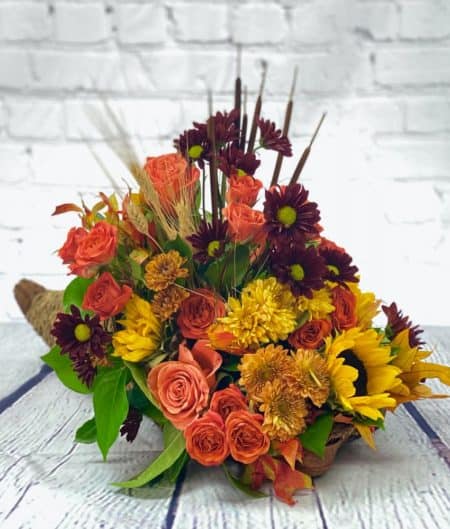This lavish cornucopia is overflowing with Fall flowers.